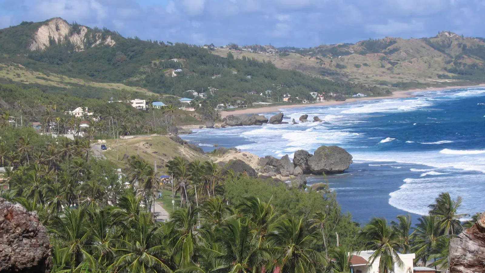Palm trees, green hills and Atlantic surf around the rock formations of Bathsheba on the east coast of Barbados