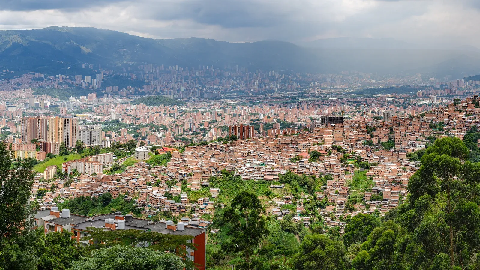 Medellín spread across the Aburrá Valley, seen from the green hillsides of Robledo, Colombia
