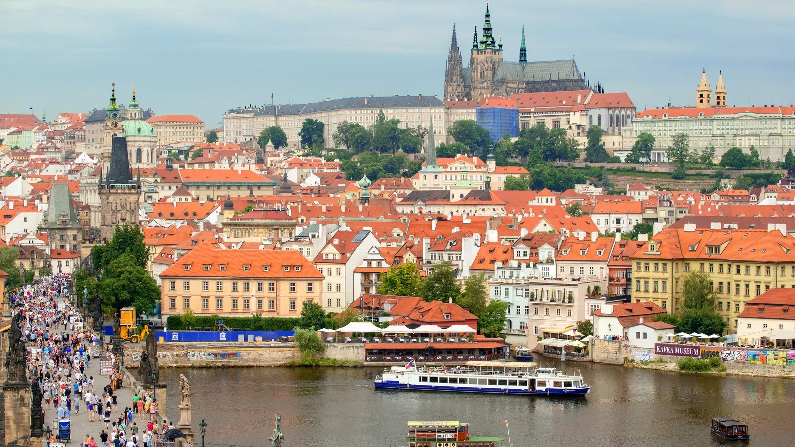Red roofs of Prague's Lesser Town below Prague Castle and St. Vitus Cathedral, with the Vltava River and Charles Bridge in front
